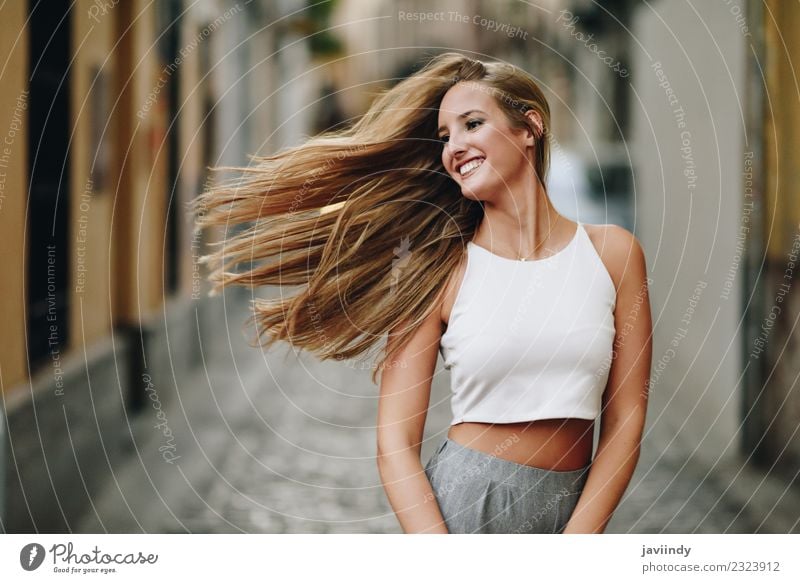 Happy young woman with moving hair in the street Lifestyle Elegant Style Beautiful Hair and hairstyles Summer Human being Feminine Young woman