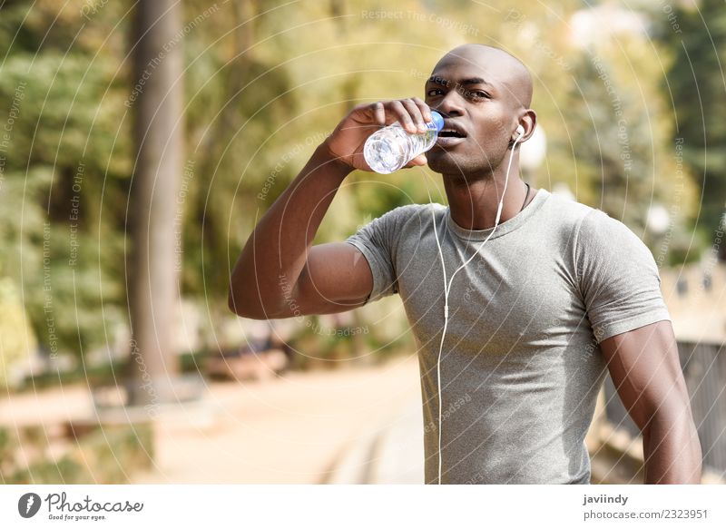 Young black man drinking water before running outdoors Drinking Bottle Lifestyle Body Sports Jogging Human being Masculine Young man Youth (Young adults) Man