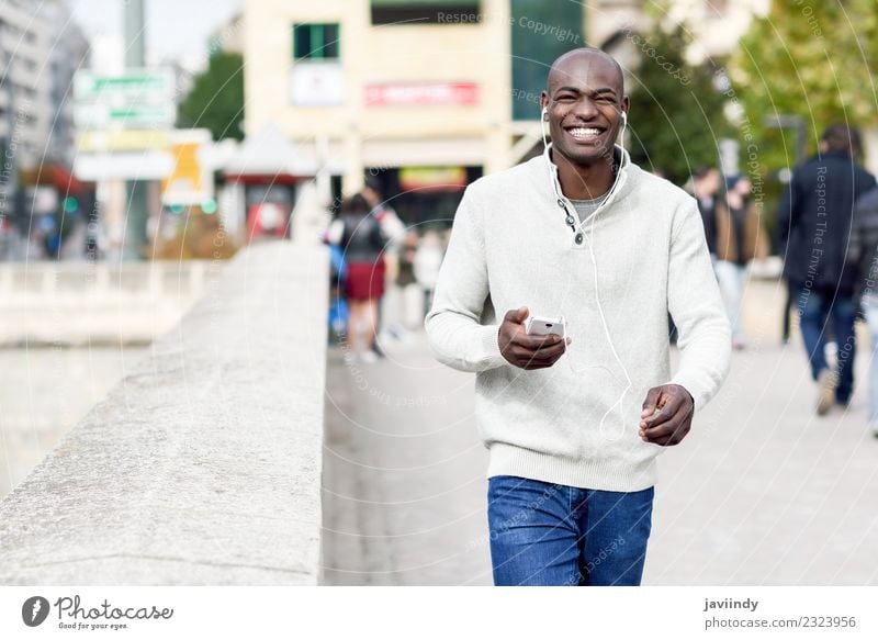 Smiling black man with smartphone in his hand Lifestyle Telephone Technology Human being Young man Youth (Young adults) Man Adults 1 18 - 30 years Street Jeans