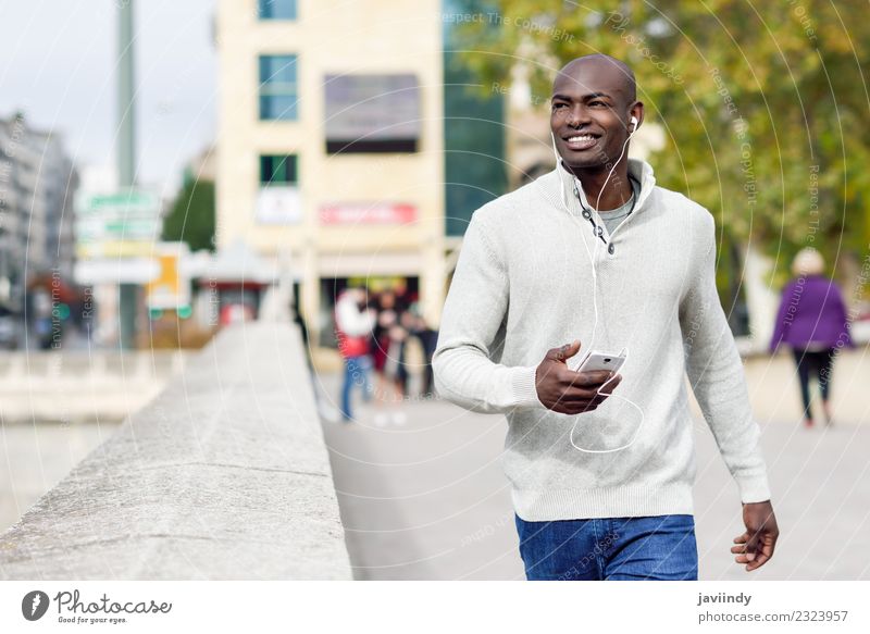 Black man with smartphone in his hand outdoors Lifestyle Happy Beautiful Face Telephone PDA Technology Human being Young man Youth (Young adults) Man Adults 1