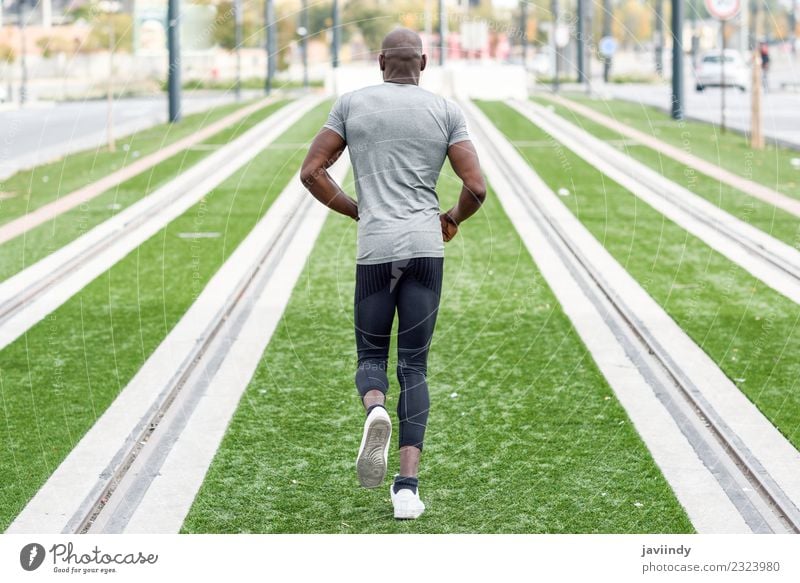 Rear view of black man running in urban background. Lifestyle Body Sports Jogging Human being Masculine Young man Youth (Young adults) Man Adults 1
