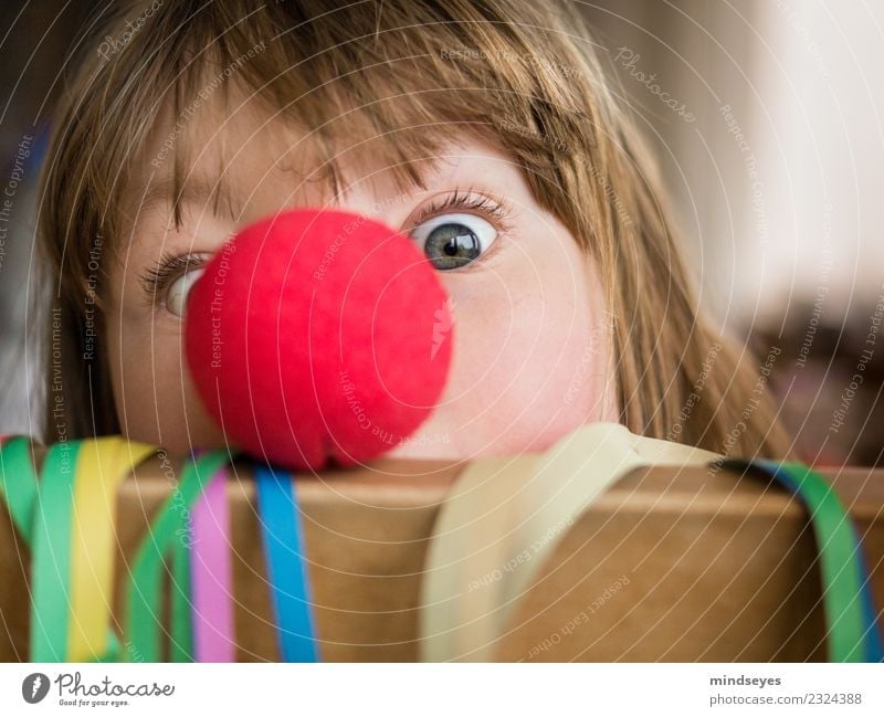 Girl with clown nose looks into the camera Carnival girl Face 1 Human being 3 - 8 years Child Infancy Party Paper streamers Feasts & Celebrations Playing Brash