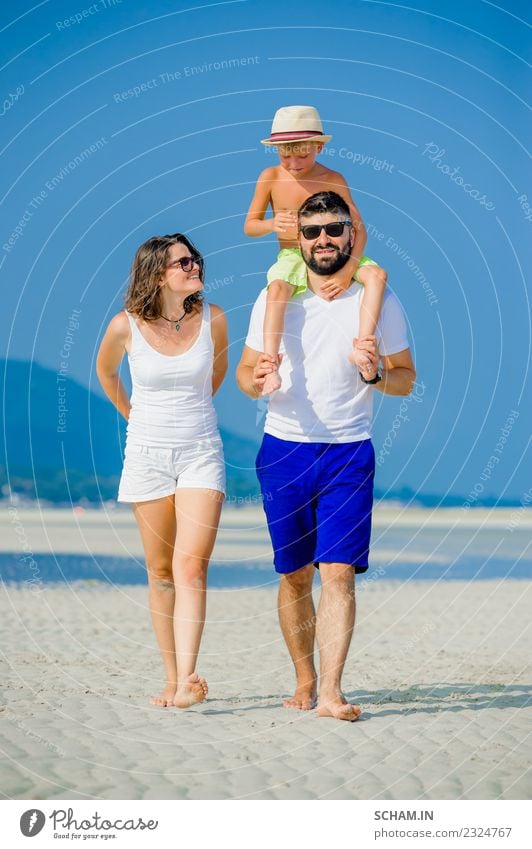 Happy young family of three at the beach Lifestyle Joy Playing Summer Ocean Island Infancy Group Sunglasses Beard Smiling Happiness Together 30-34 years