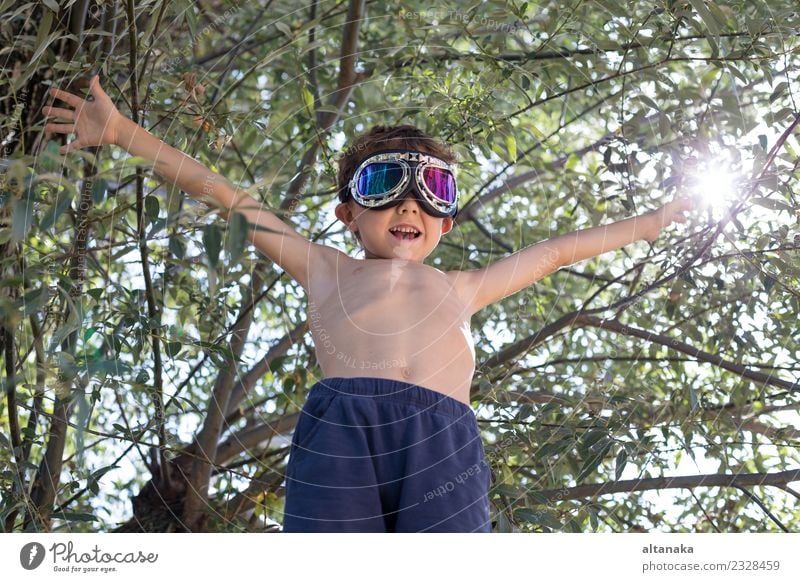 Happy little boy playing outdoors near a tree Lifestyle Joy Playing Vacation & Travel Trip Adventure Freedom Summer Success Child Pilot Human being Boy (child)