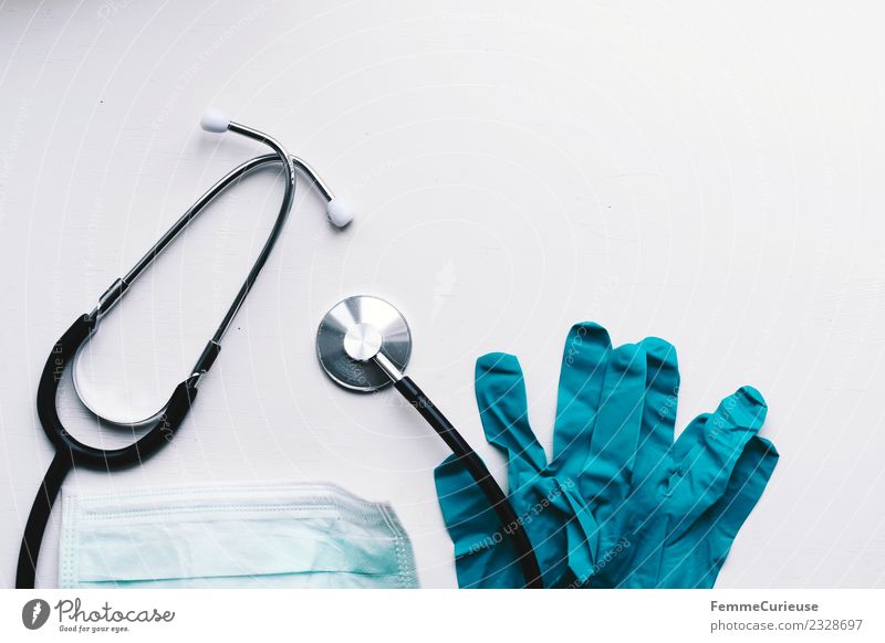 Stethoscope, protective gloves and face mask on table Work and employment Profession Doctor Competent Mask Gloves Turquoise Still Life Tabletop White Medication