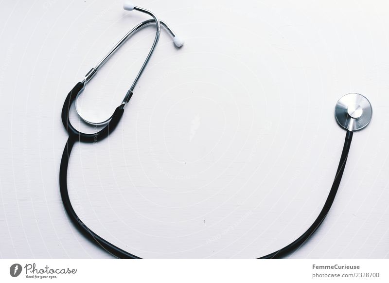 Stethoscope on white table Work and employment Profession Doctor Competent Tabletop White Medication Hospital consultation hour Colour photo Interior shot