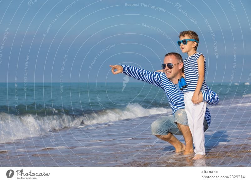 Father and son playing on the beach at the day time. Lifestyle Joy Happy Relaxation Leisure and hobbies Playing Vacation & Travel Trip Freedom Camping Summer