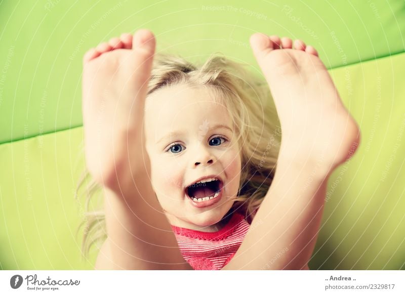 Feet up ... Child Toddler Girl Face 1 Human being 1 - 3 years Movement Fitness Smiling Laughter Lie Playing Sports Happiness Fresh Healthy Happy Beautiful Cute