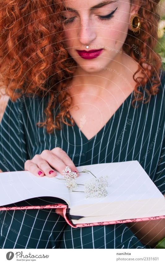 Young redhead woman holding an open book Lifestyle Elegant Style Beautiful Hair and hairstyles Skin Face Make-up Leisure and hobbies Student Human being