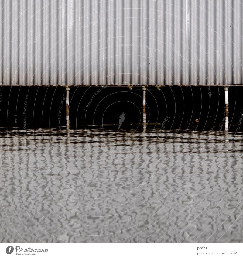 boathouse Water River bank Wall (barrier) Wall (building) Facade Metal Steel Rust Brown Gray Black White Corrugated sheet iron Support Channel Boathouse