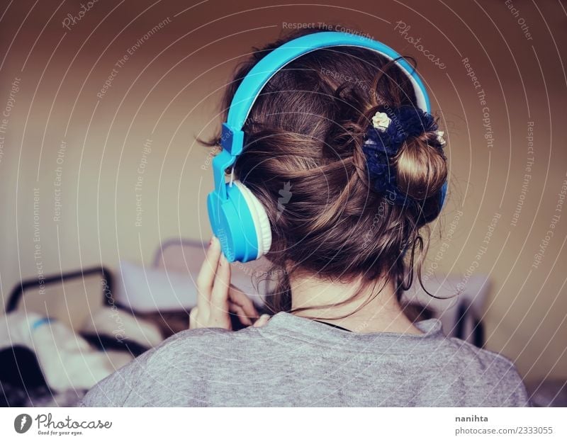 Back view of a young woman listening to music Lifestyle Style Hair and hairstyles Harmonious Senses Relaxation Leisure and hobbies Living or residing