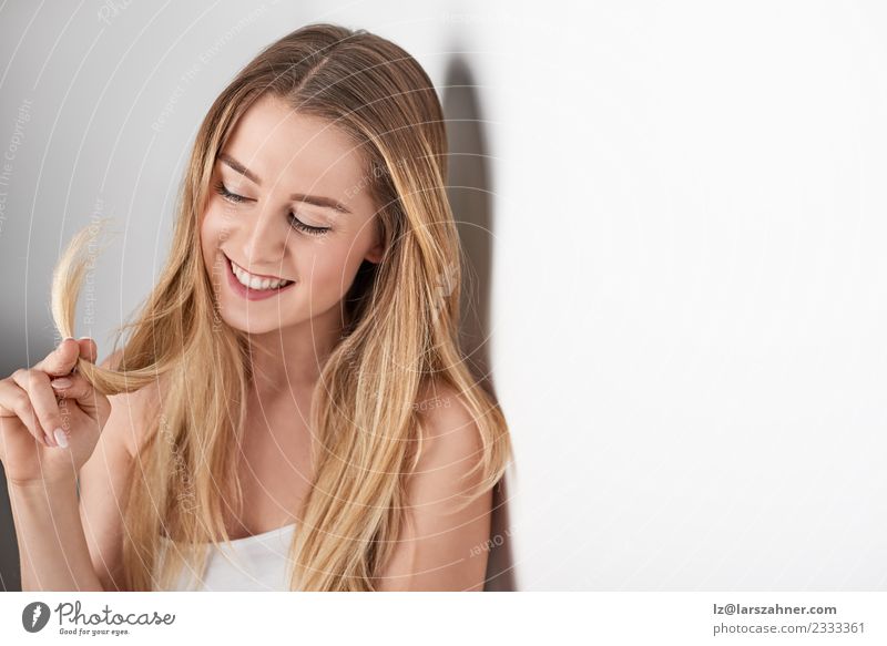 Young smiling blond woman leaning againt wall Lifestyle Happy Beautiful Face Medical treatment Woman Adults 1 Human being 18 - 30 years Youth (Young adults)