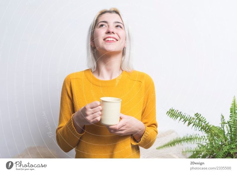 Happy young woman with a beaming warm smile Breakfast Beverage Drinking Hot drink Coffee Espresso Tea Lifestyle Style Beautiful Face Health care Relaxation Room