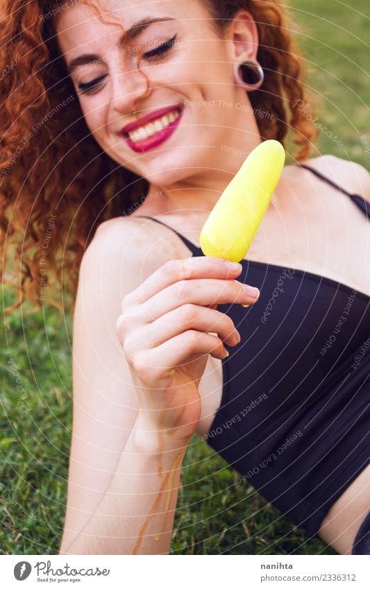 Young woman outdoors holding a lemon ice cream Food Ice cream Eating Lifestyle Style Joy Beautiful Hair and hairstyles Skin Face Summer Summer vacation