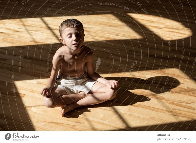 Charming little boy is while doing yoga at home at the day time. Lifestyle Joy Happy Body Harmonious Relaxation Meditation Leisure and hobbies Playing Camping