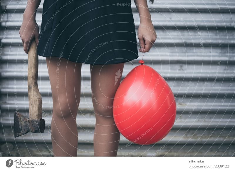 Teenage girl standing near a wall with balloon and axe Lifestyle Body Axe Human being Woman Adults Youth (Young adults) Hand Park Fashion Balloon Sadness Wait