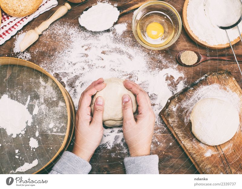 hands hold a ball of yeast dough Dough Baked goods Bread Bowl Table Kitchen Woman Adults Arm Hand 1 Human being 18 - 30 years Youth (Young adults) Sieve Wood
