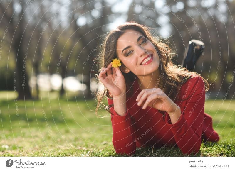 Smiling woman lying on grass in urban park. Lifestyle Style Beautiful Hair and hairstyles Face Relaxation Summer Human being Feminine Young woman