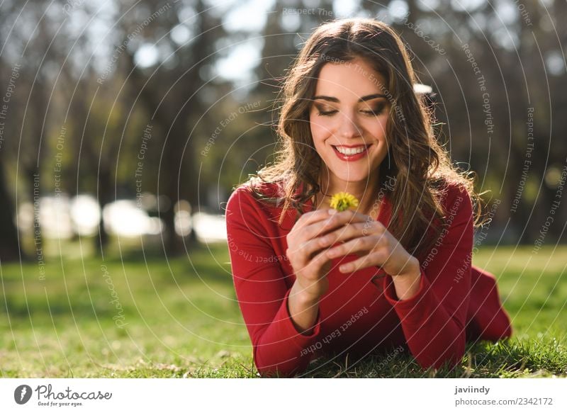 Young woman lying on grass in urban park. Lifestyle Style Happy Beautiful Hair and hairstyles Face Relaxation Summer Human being Feminine Youth (Young adults)