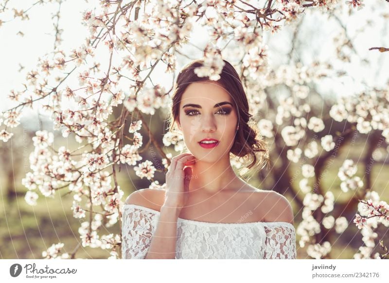 Young woman between almonds flowers in spring time Style Beautiful Human being Feminine Youth (Young adults) Woman Adults 1 18 - 30 years Nature Tree Flower