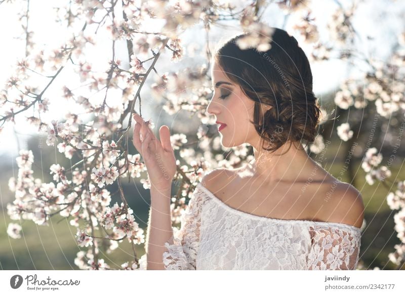 Young woman between almonds flowers in spring time Style Beautiful Face Human being Feminine Youth (Young adults) Woman Adults 1 18 - 30 years Nature Tree