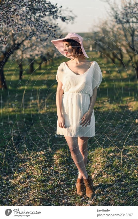 Young woman in almond flowered field in spring time Style Happy Beautiful Hair and hairstyles Face Human being Feminine Youth (Young adults) Woman Adults 1