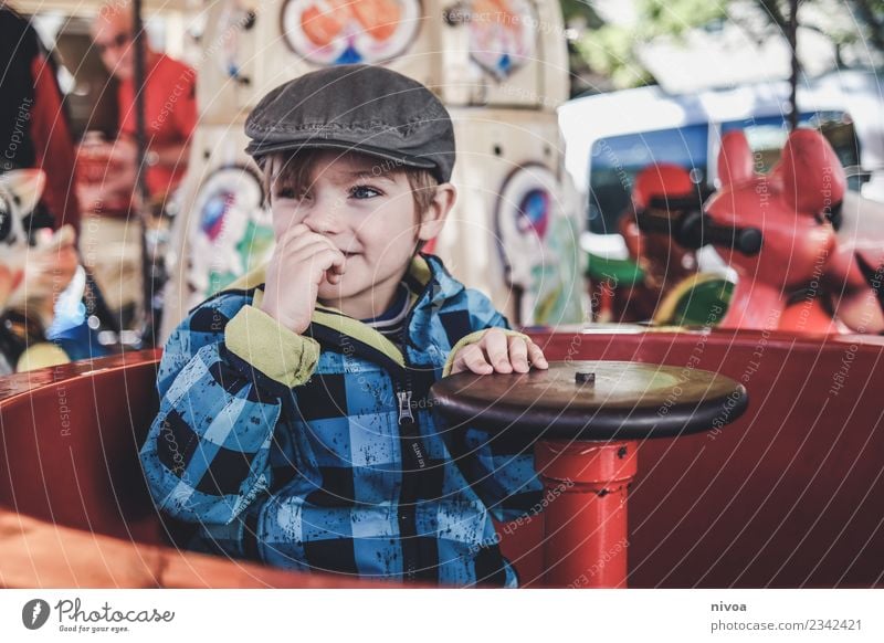 Boy in a merry-go-round Leisure and hobbies Children's game Carousel Entertainment Entertainment electronics Human being Masculine Boy (child) Head 1