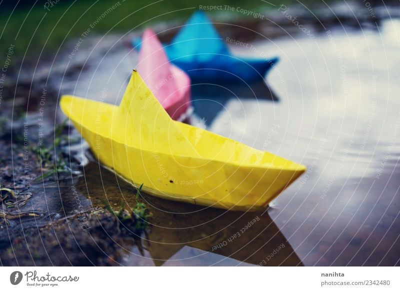 Color paper boats in a puddle Leisure and hobbies Playing Paper Paper boat Childhood memory Children's game Environment Nature Water Drops of water Climate