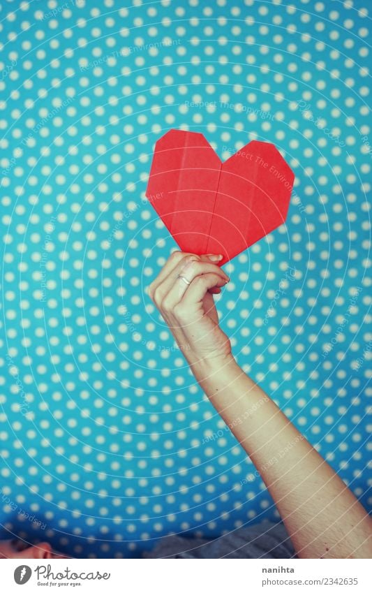 Hand holding a red paper heart against blue background Design Feasts & Celebrations Valentine's Day Mother's Day Human being Feminine Young woman