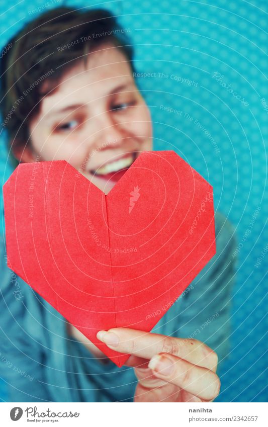 Young happy woman holding a red paper heart Lifestyle Joy Beautiful Healthy Health care Wellness Well-being Leisure and hobbies Handcrafts Origami