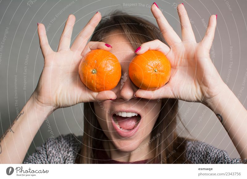 Portrait of surprised woman with oranges Fruit Orange Lifestyle Joy Healthy Wellness Feminine Young woman Youth (Young adults) Woman Adults Diet Laughter Free