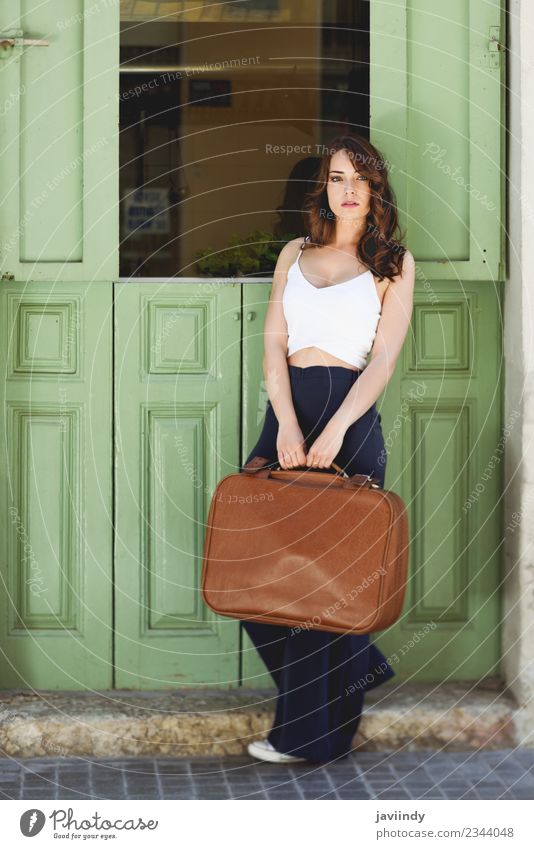 Beautiful girl with vintage bag against green door Lifestyle Style Hair and hairstyles Vacation & Travel Tourism Trip Summer Human being Feminine Young woman