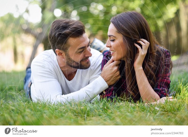 Beautiful young couple laying on grass in an urban park Lifestyle Joy Summer Human being Young woman Youth (Young adults) Young man Woman Adults Man Couple 2