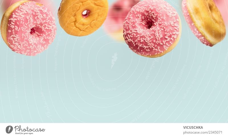 Pink doughnuts on blue Cake Nutrition Style Design Donut To fall Floating Food photograph Eating Background picture Colour photo Interior shot Studio shot