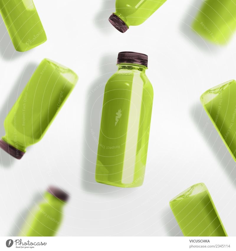 Green smoothie or juice bottles on white background Food Organic produce Vegetarian diet Diet Beverage Cold drink Juice Bottle Style Design Summer Hip & trendy