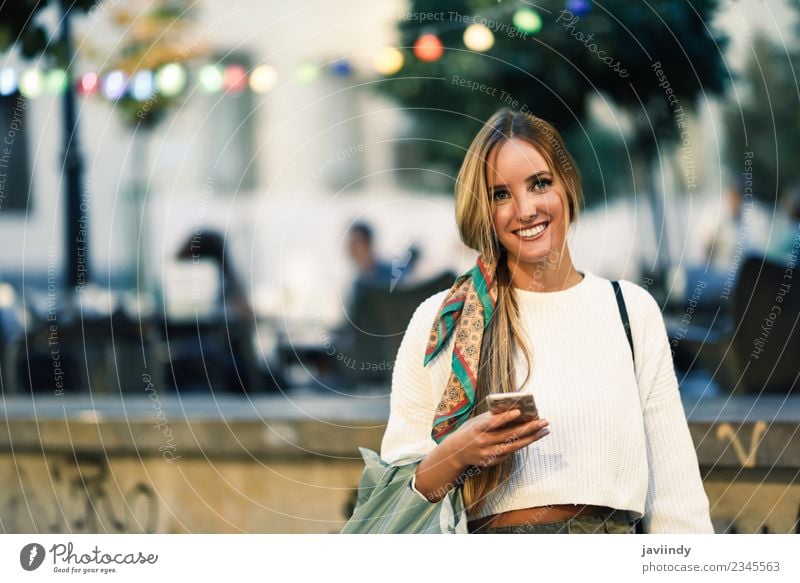Blonde woman with smart phone in the street. Lifestyle Style Happy Beautiful Hair and hairstyles Telephone PDA Human being Feminine Young woman