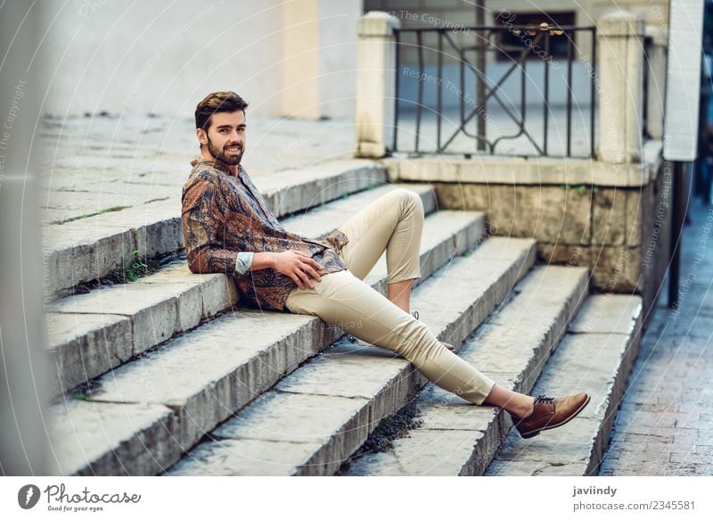 Young smiling man sitting on urban steps Lifestyle Style Beautiful Hair and hairstyles Human being Masculine Young man Youth (Young adults) Man Adults 1