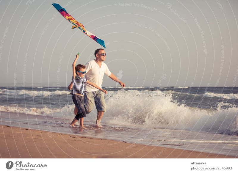 Father and son playing on the beach at the day time. Lifestyle Joy Happy Relaxation Leisure and hobbies Playing Vacation & Travel Trip Adventure Freedom Camping