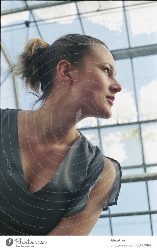 analogue portrait of a young woman standing in a glass greenhouse already Life Senses Sky Snow Greenhouse Window Young woman Youth (Young adults) Face décolleté
