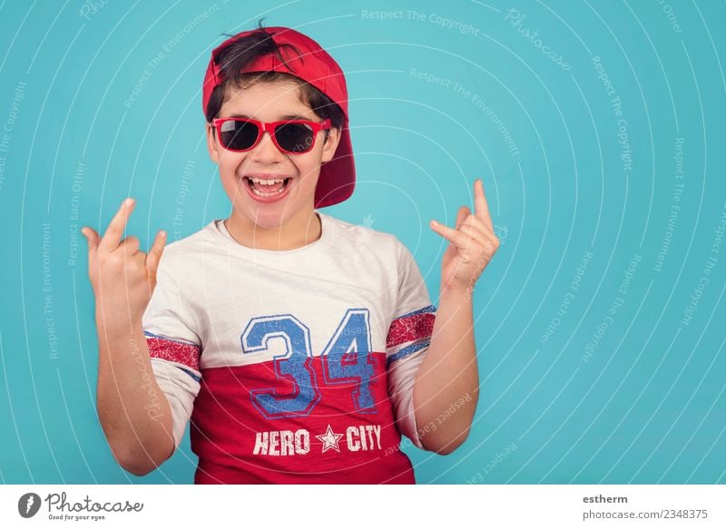 funny child with cap and sunglasses Human being Child Boy (child) Infancy 1 8 - 13 years Sunglasses Cap Smiling Laughter Funny Modern Emotions Happiness