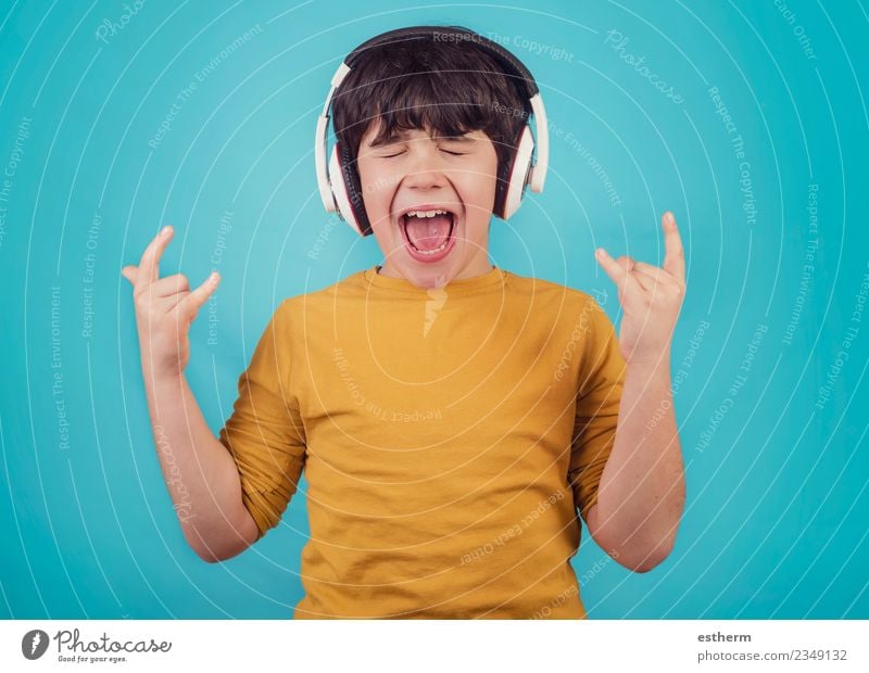 Boy with headphones showing rock sigh Lifestyle Joy Human being Masculine Boy (child) Infancy 1 3 - 8 years Child Party Music Listen to music Concert Singer