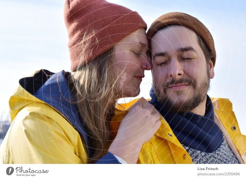 pair - caps - eyes closed Young woman Youth (Young adults) Young man Couple Partner 2 Human being 18 - 30 years Adults Rain jacket Facial hair Breathe Touch