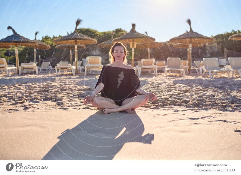 Attractive barefoot woman meditating on the beach Happy Relaxation Calm Meditation Leisure and hobbies Vacation & Travel Summer Beach Yoga Woman Adults Sand Sit