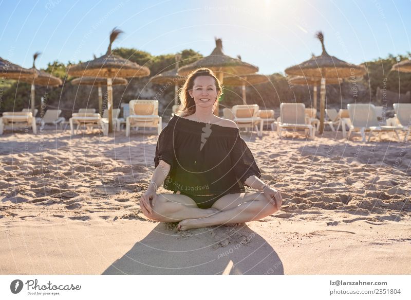 Smiling barefoot woman sitting on the beach Happy Relaxation Meditation Leisure and hobbies Vacation & Travel Summer Beach Yoga Woman Adults 1 Human being