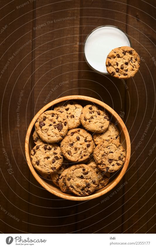 Chocolate Chip Cookies with Milk Dairy Products Dessert Candy Breakfast Natural chocolate cookie biscuit food Snack sweet Baking glass cold drink Rustic wood