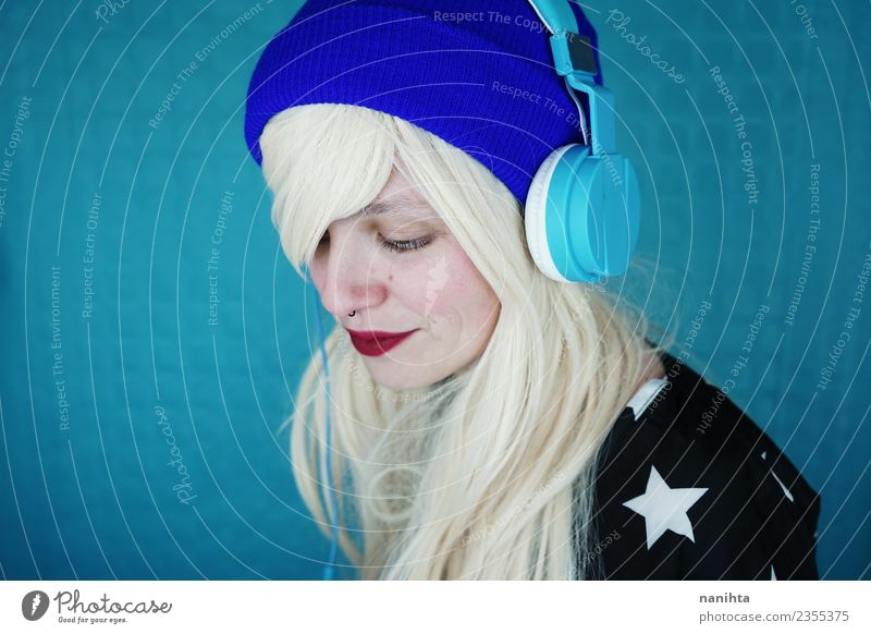 Young blonde woman listening to music Lifestyle Style Design Joy Beautiful Hair and hairstyles Skin Face Leisure and hobbies Headset Technology