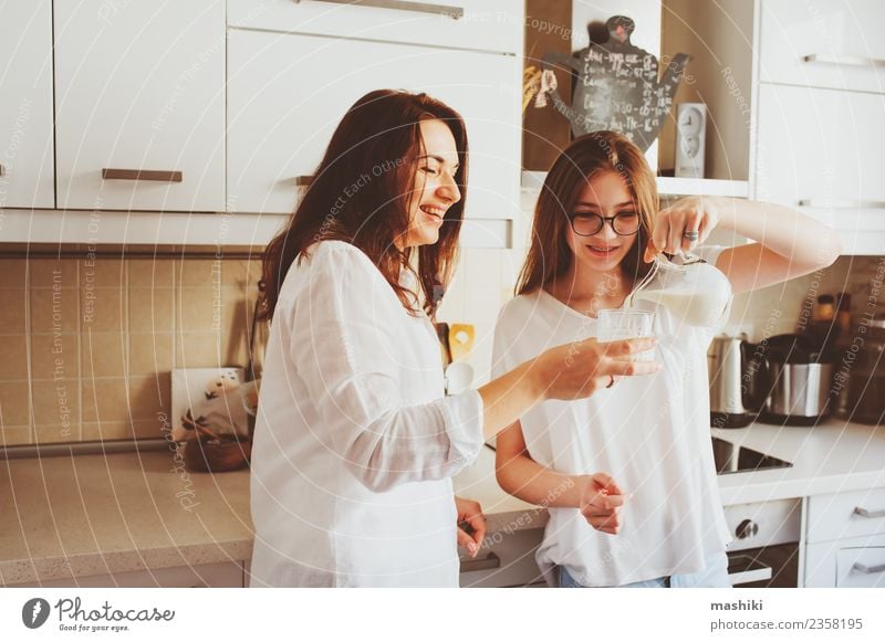 mother having breakfast with teen daughter Breakfast Lifestyle Joy Kitchen Child Mother Adults Sister Family & Relations Youth (Young adults) Smiling Embrace