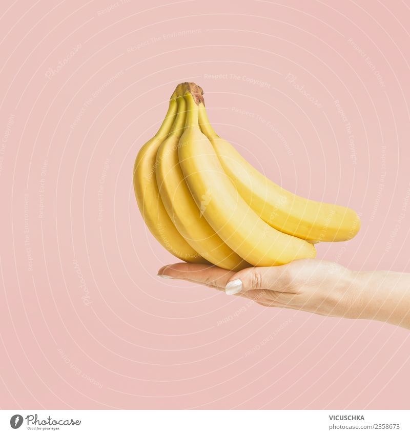Hand with bananas Food Fruit Nutrition Organic produce Vegetarian diet Diet Lifestyle Style Design Joy Healthy Eating Summer Feminine Summery Banana on pink
