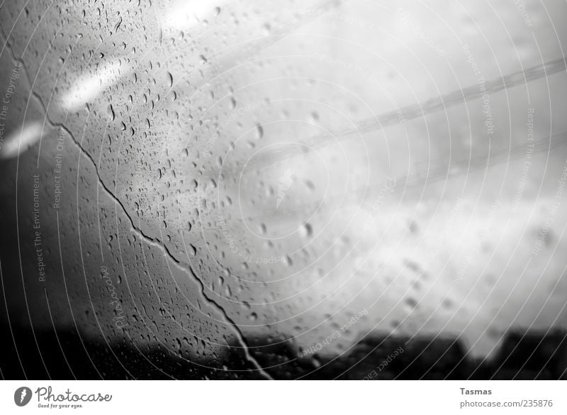 Rainy Mood Weather Bad weather Storm Cold Slice Glass Window pane Train window Drops of water Train travel Black & white photo Close-up Abstract Deserted Shadow