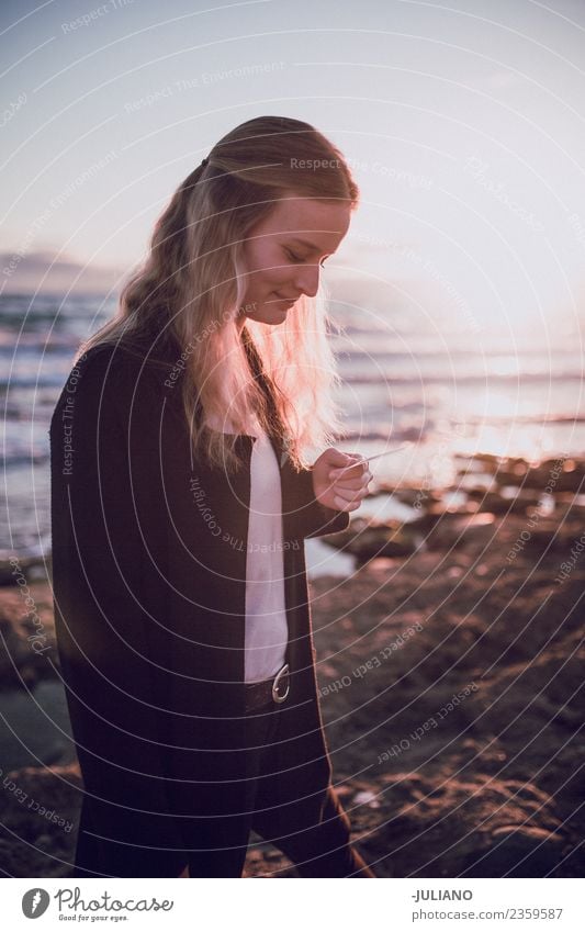 Young woman is looking at polaroid picture at the beach Beach Dusk Emotions Happy Life Lifestyle Spain Summer Sun Sunset Warmth Adventure Communicate